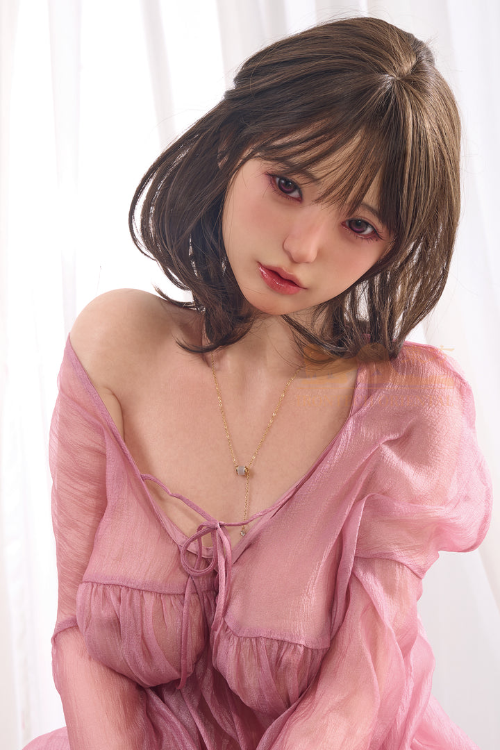 Irontech Doll 153T Miku silicone sex doll wearing a sheer pink dress, posing softly with a natural expression and short brown hair