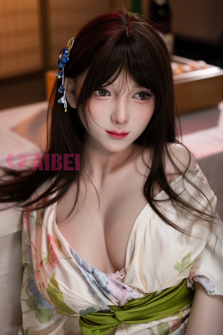 Close-up of Aibei Doll Rika with long dark hair, wearing a floral kimono-style dress with a green waist sash, featuring realistic facial details and soft expression.