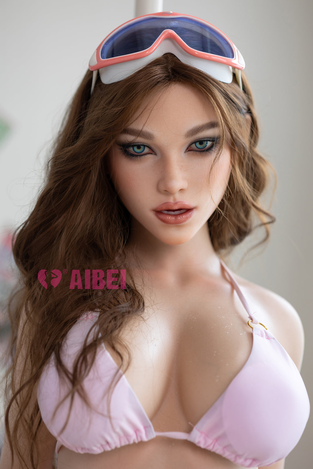 Aibei Doll 158 cm F Silicone – Aria wearing a light pink bikini and ski goggles on her head, featuring lifelike facial details and realistic silicone skin texture.