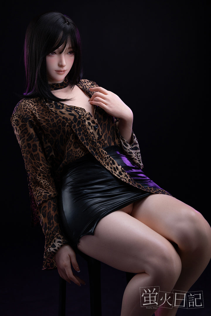 Full-body view of Firefly Diary Doll 161 cm Silicone – Linglong seated on a chair, wearing a leopard-print top and black skirt, highlighting her lifelike skin tone and natural sitting pose.