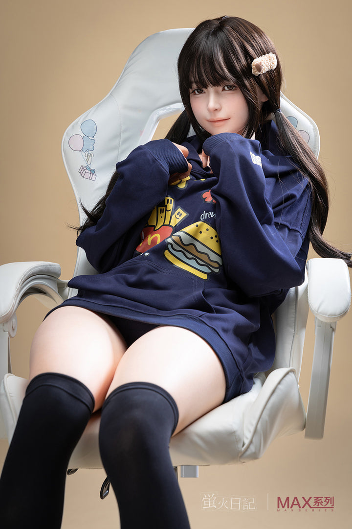 Full-body view of Firefly Diary Doll 165 cm Max Series Silicone – Qiandao seated in a chair, wearing a navy hoodie and thigh-high black socks with a neutral indoor backdrop.