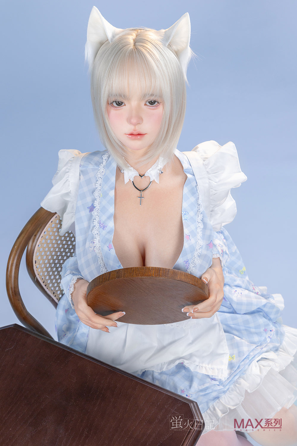Firefly Diary Doll 160 cm Max Series Silicone - Lolita seated at a table, holding a small round wooden tray, wearing a blue checkered ruffled dress and a heart-shaped choker.
