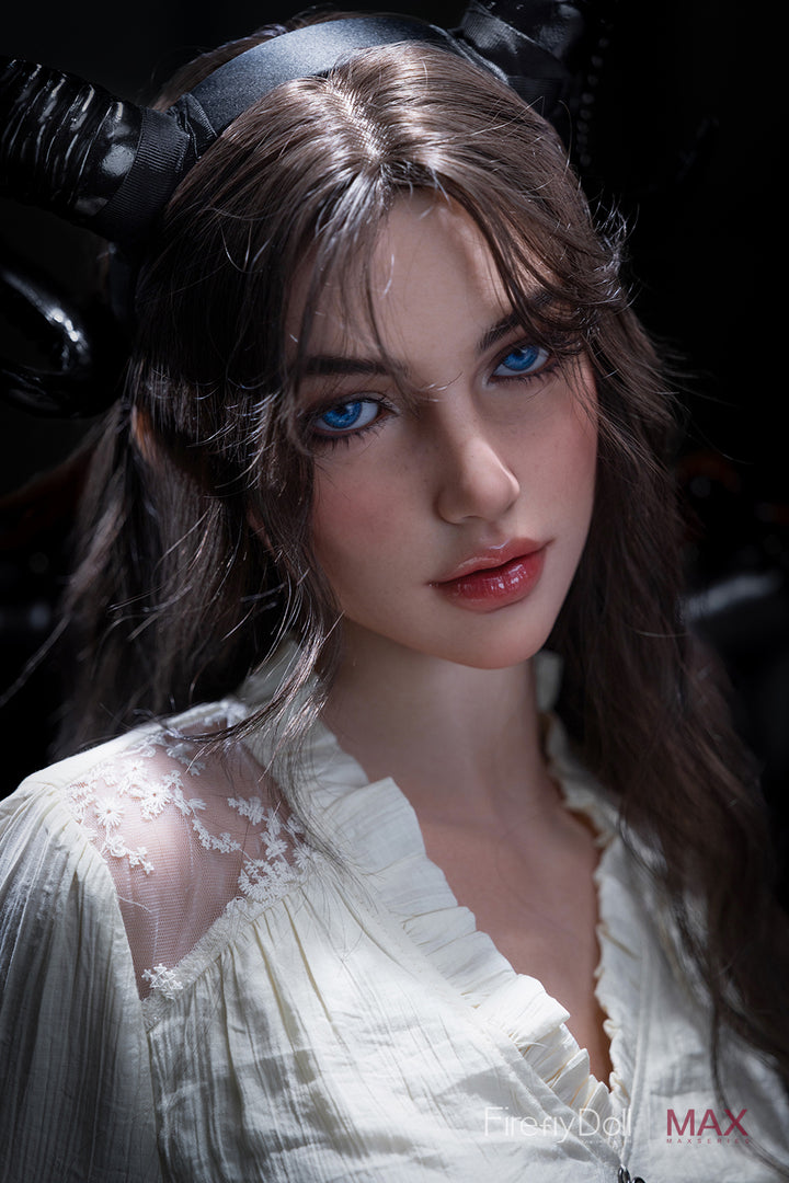 Close-up of Firefly Diary Doll 165 cm Max Series Silicone – Mary V4 with long brown hair, striking blue eyes, and natural makeup, wearing a white lace blouse under soft lighting.