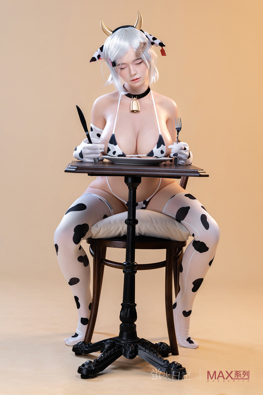 Firefly Diary Doll 160 cm Max Series Silicone - Liu Li V4 sitting at a table with a fork and knife, wearing a cow-print bikini and matching cow ears and horns.