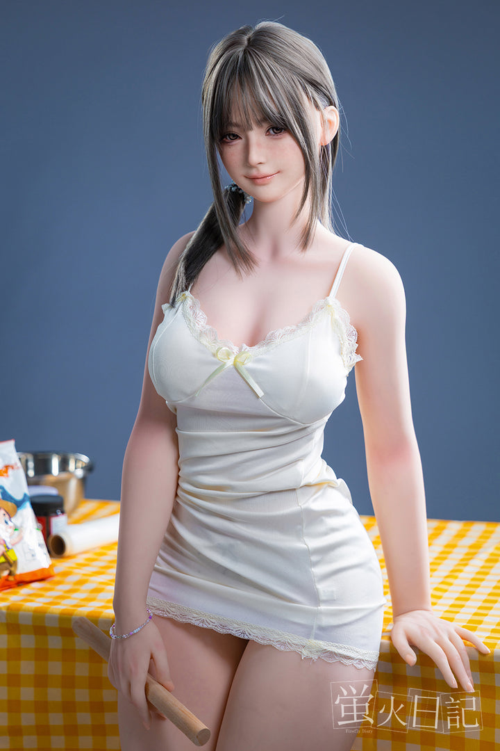 Firefly Diary Doll Qiandao – 159 cm silicone love doll with soft facial features, dressed in cream outfit, posed in realistic home setting.