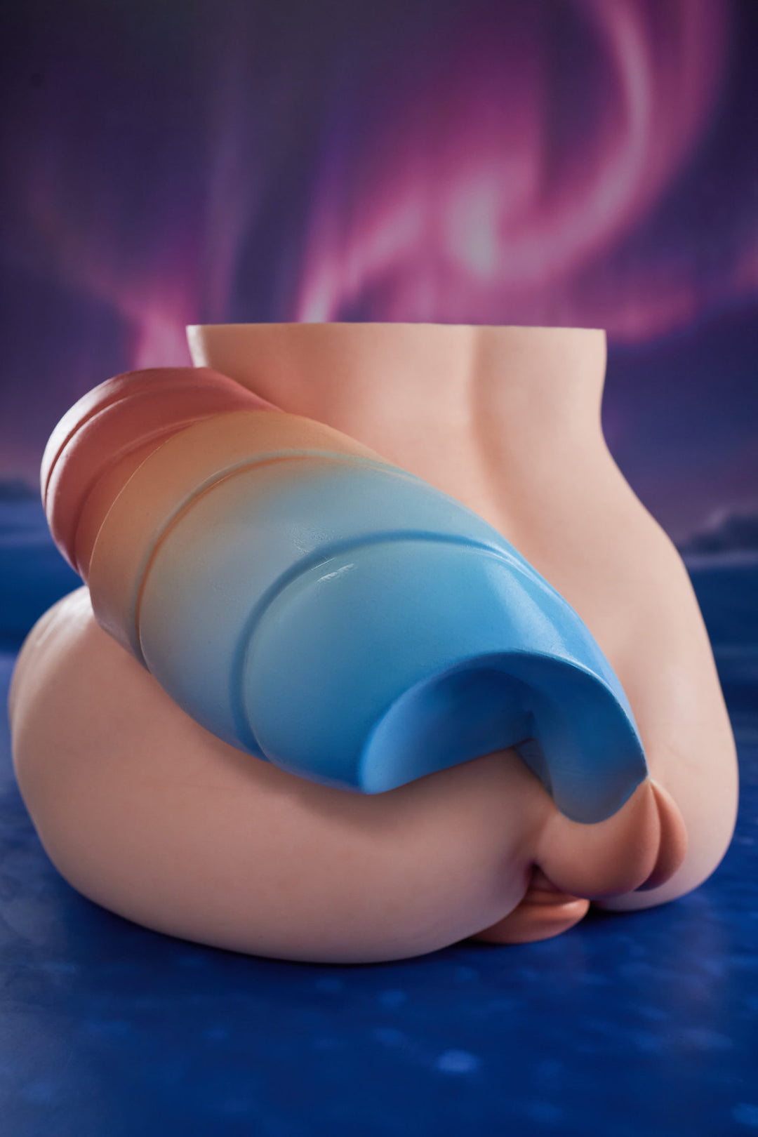 CLIMAX DOLL - PA-Ray Silicone Butt Torso (Cinnamon) rear three-quarter view with blue hair accessory detail, blue aurora background
