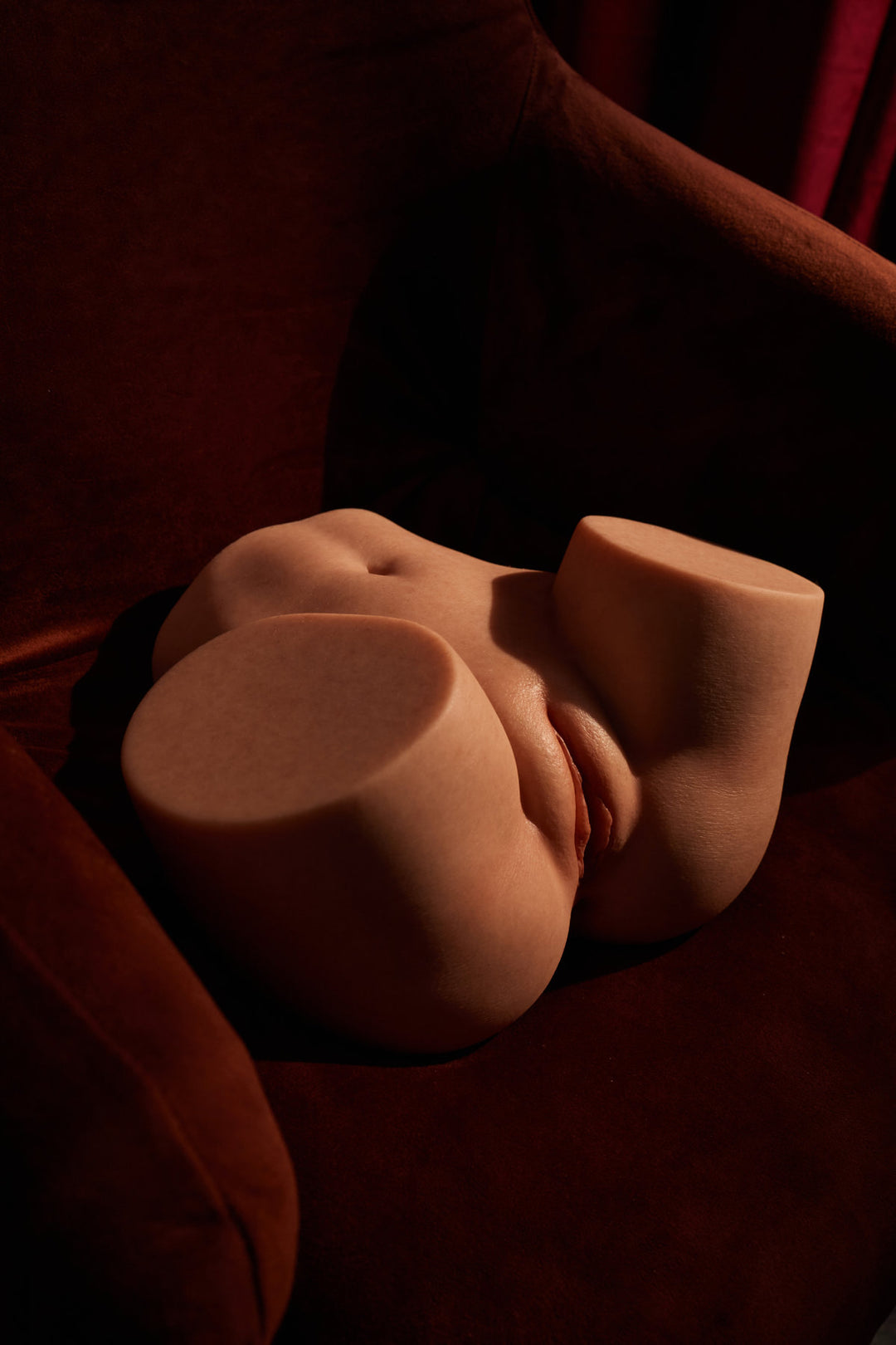 CLIMAX DOLL - PW-A45 Silicone Butt Torso (Natural) close-up front view showing removable insert detail, dark red background
