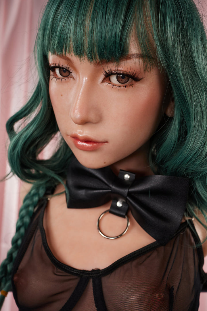 A close-up headshot of the green-haired CLIMAX DOLL - ULW 881# Silicone Torso - Mayu (Natural) detailing the facial features and the black bow collar.