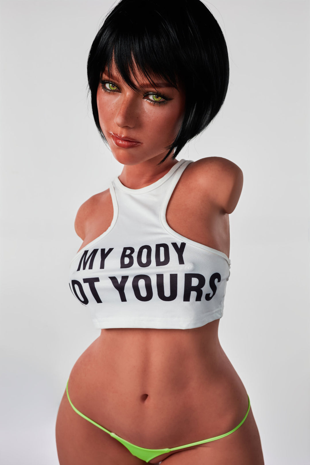 A front view of the CLIMAX DOLL - ULW 882# Silicone Torso - Livia (Black), featuring a doll with short black hair wearing a white crop top that says "MY BODY NOT YOURS" paired with neon green bikini bottoms.