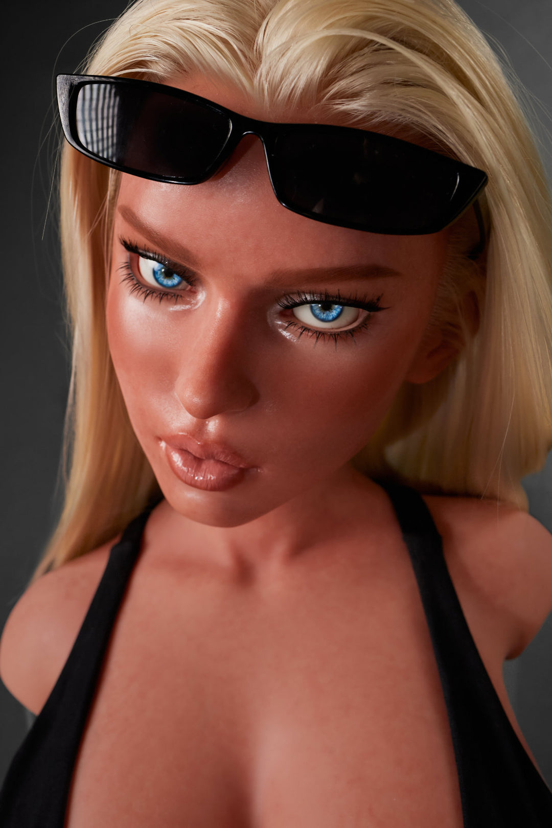 A close-up headshot of the blonde CLIMAX DOLL - ULW 883# Silicone Torso - Fiora (Black) with sunglasses resting on her forehead.