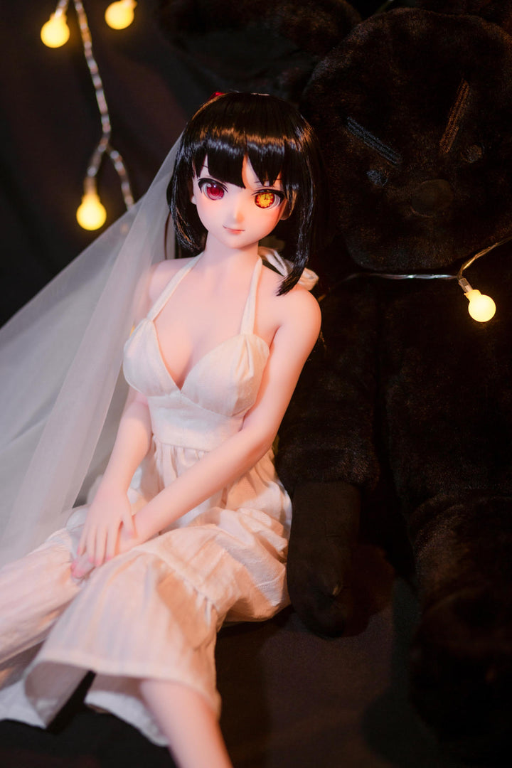 CLIMAX DOLL Mini J60 cm Hybrid - Kurumi (Cinnamon) - Seated pose in the white gown with legs crossed, veil around her shoulders, soft expression, fairy lights glowing behind.