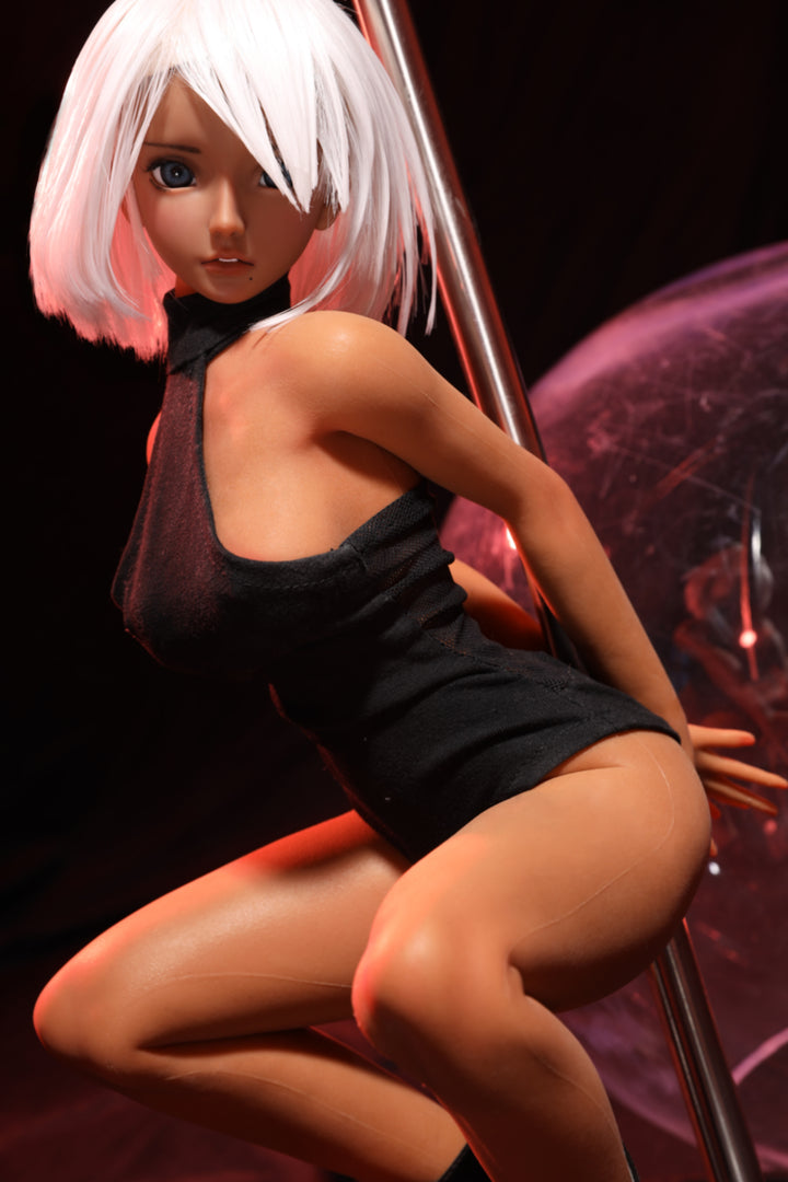 CLIMAX DOLL Mini J60 cm Hybrid - Shirley (Suntan) – seated on a glossy sphere prop in black bodysuit