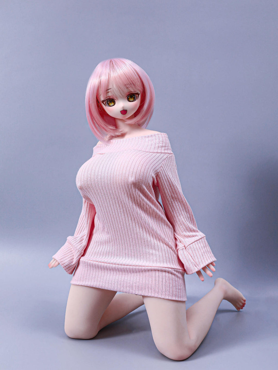 CLIMAX DOLL Mini J60cm P Hybrid - Azami (Cinnamon) kneeling pose in the oversized pink sweater dress, short pink bob, lavender-gray backdrop