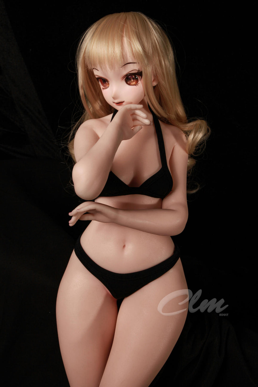 CLIMAX DOLL Mini J60cm XS Hybrid - Nagisa (Cinnamon) standing pose in a black bikini set with arms crossed over her chest, black backdrop