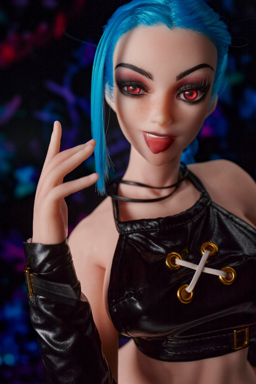 CLIMAX DOLL Mini Si70cm MO Silicone - Jetta (Cinnamon) close-up upper body shot in black crop top with gold cross pendant and black gloves, blue hair, dark bokeh background
