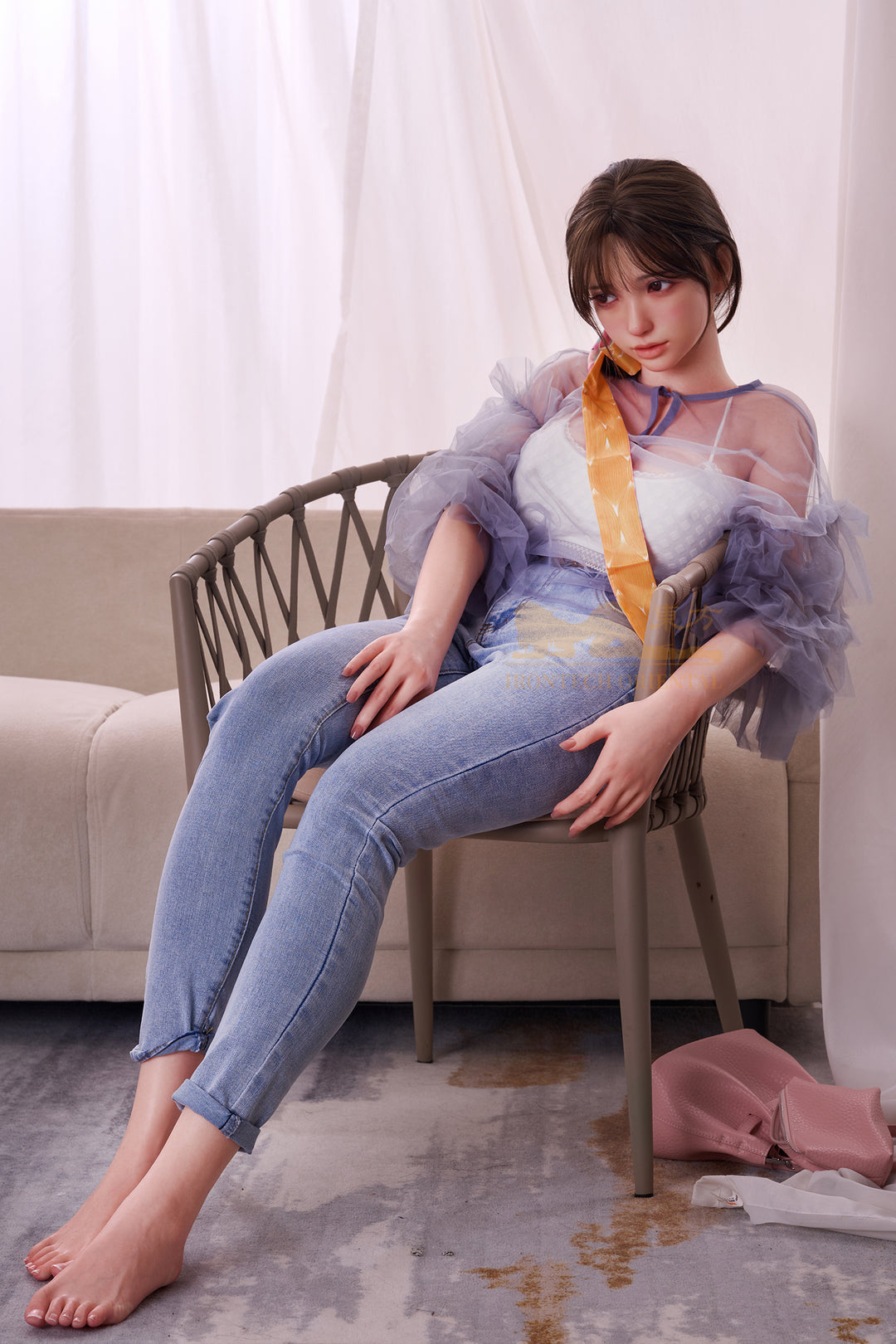 Full body view of Irontech Doll 161T Evie sitting on a sofa in sheer purple lingerie, showing realistic skin tone and delicate curves.