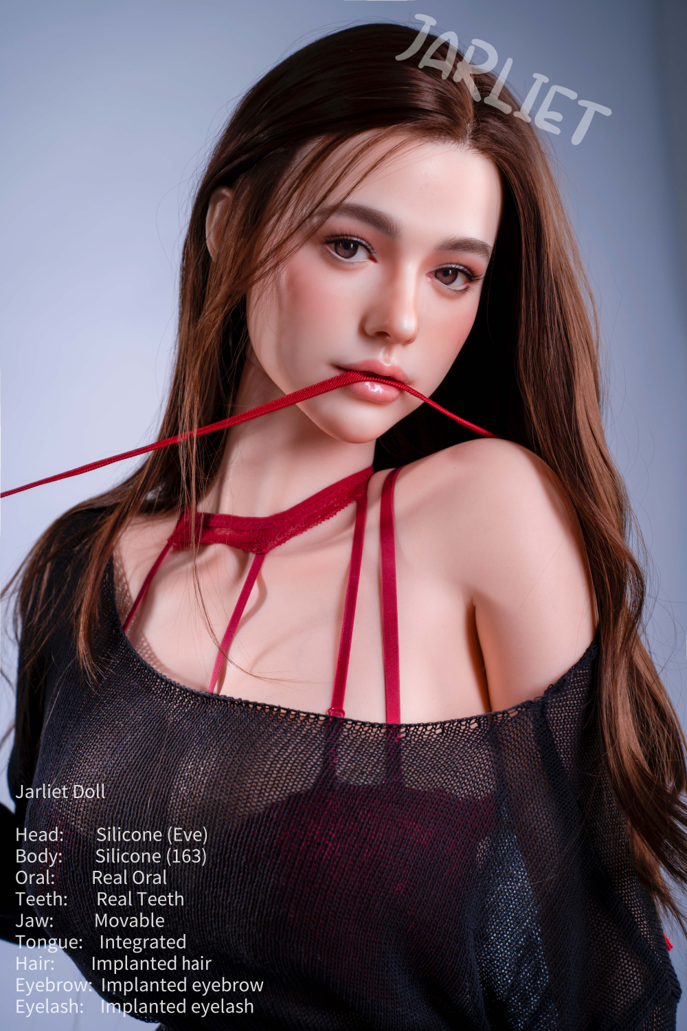 A close-up portrait of the Jarliet Doll 163 cm D Silicone - Eve with her head tilted slightly. She is holding a thin red strap in her mouth, highlighting her realistic facial features and implanted hair. She is wearing the same sheer black sweater and red lingerie set.