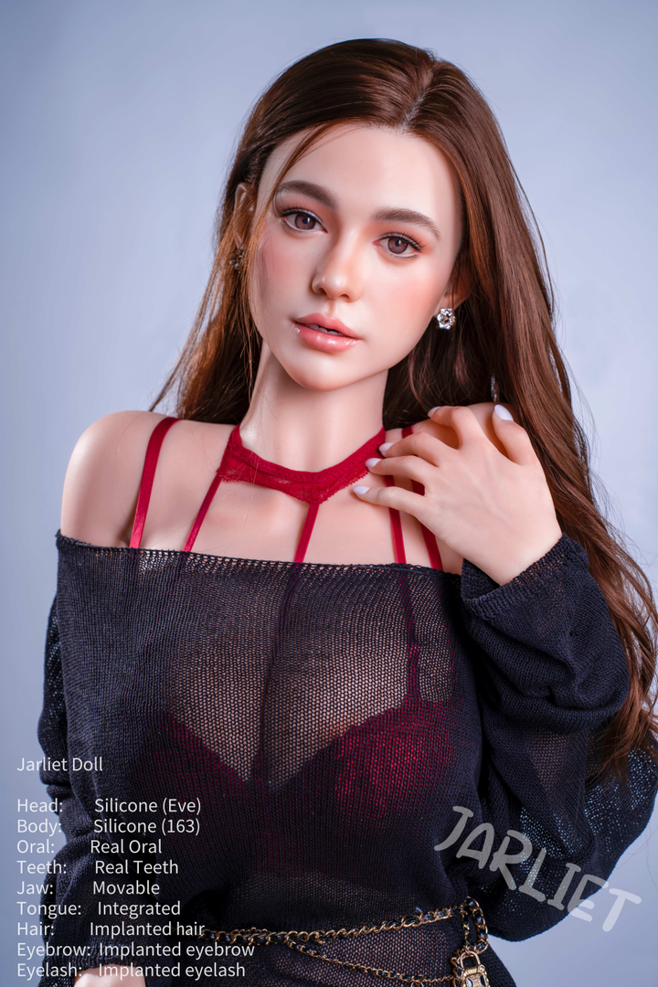 A mid-shot of the Jarliet Doll 163 cm D Silicone - Eve looking directly at the camera. She is styled with long brown hair and is wearing a sheer black sweater over red lingerie, featuring a choker-style neckline.