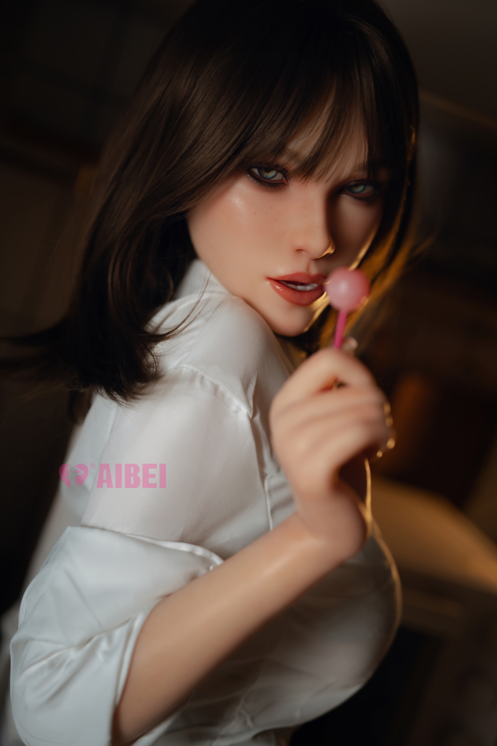 Aibei Doll 158 cm F Silicone – Aria V2 playfully holding a lollipop while wearing a white top, showcasing her youthful and expressive design.