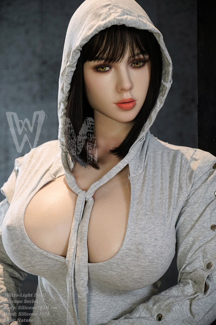 A medium shot of WM DOLL 163 CM H-cup Ultra Light SILICONE - #198 V2 highlighting the realistic skin texture and golden-blonde hair, styled in a white fur ensemble.