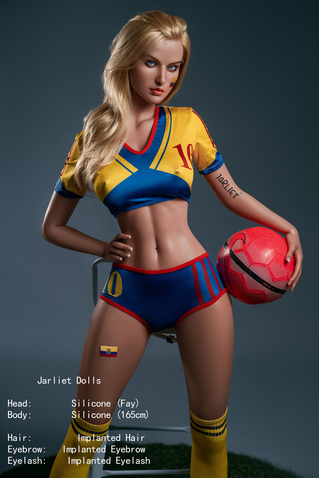 Full-body front view of the Jarliet Fay doll, a 165 cm silicone figure with blonde hair and blue eyes, dressed in a yellow and blue soccer-themed crop top and shorts while holding a red soccer ball.