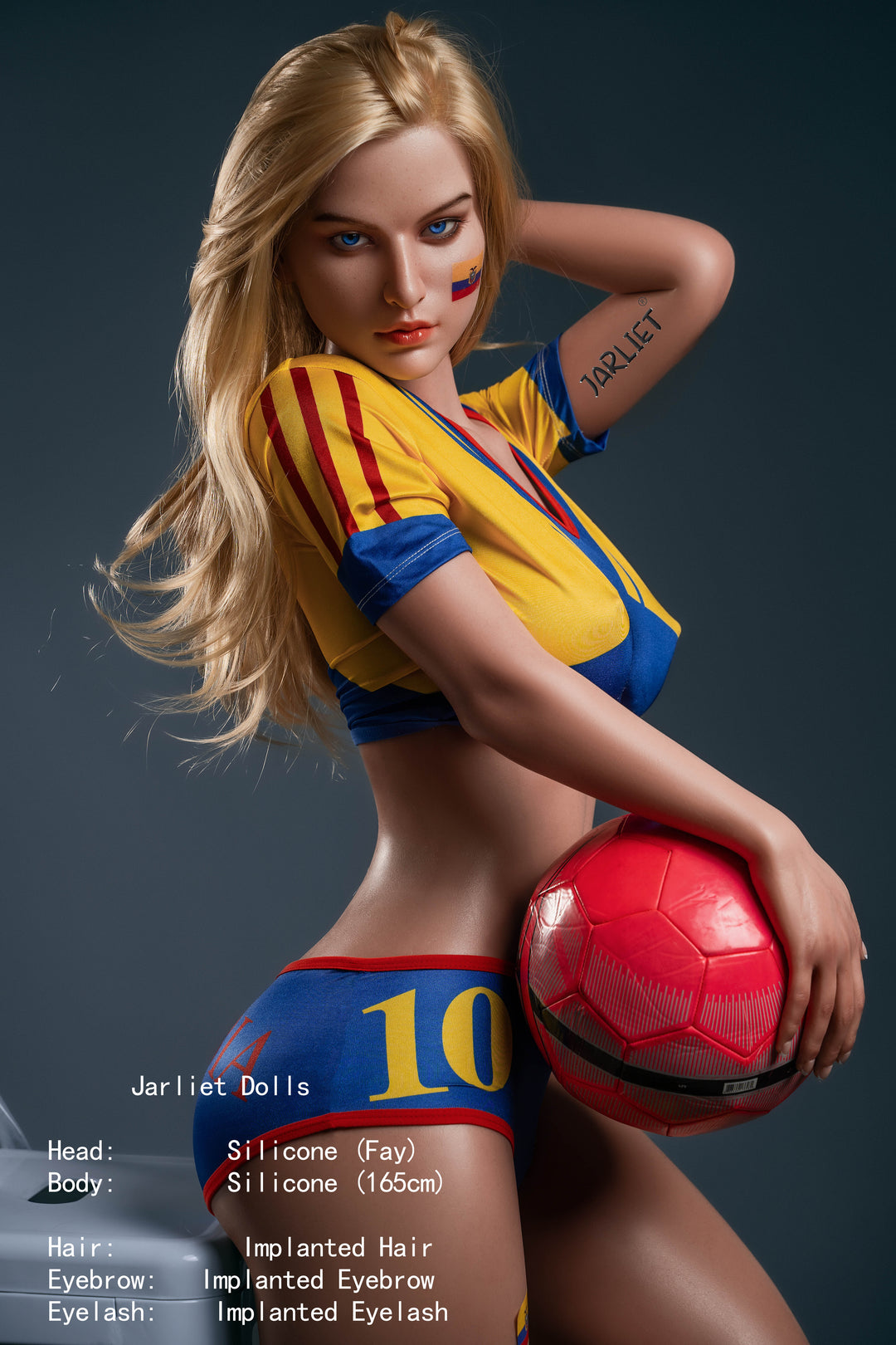 A dynamic side-view pose of the Jarliet Fay doll with one hand behind her head and the other holding a red soccer ball, highlighting the realistic silicone details and blonde hair.
