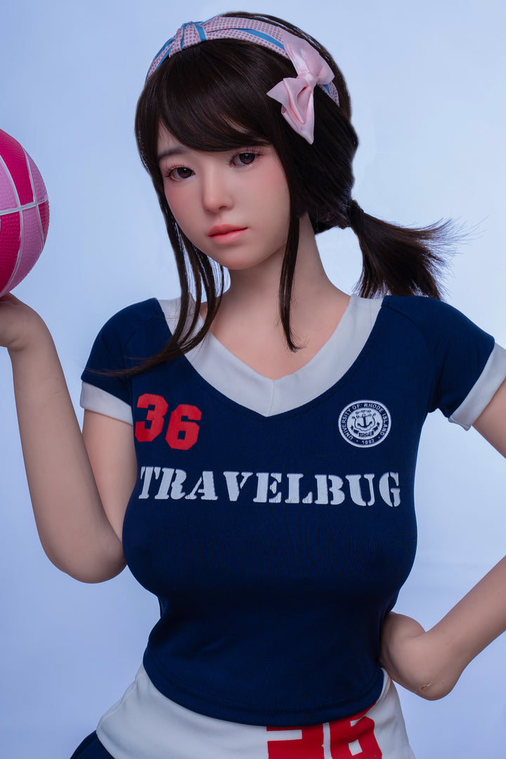 TAYU Nova Series 148 cm D-Cup Hybrid Doll – Yuki, with short brown hair, wearing a sporty “Travelbug” outfit, posed with a pink basketball.