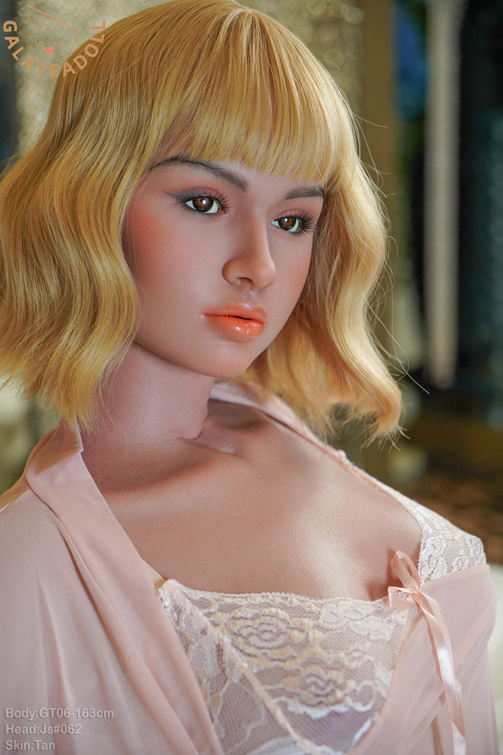 Galatea Doll 163 cm D Silicone - JS062 V2 close-up view, featuring short blonde wavy hair, soft makeup, and a pink lace robe.