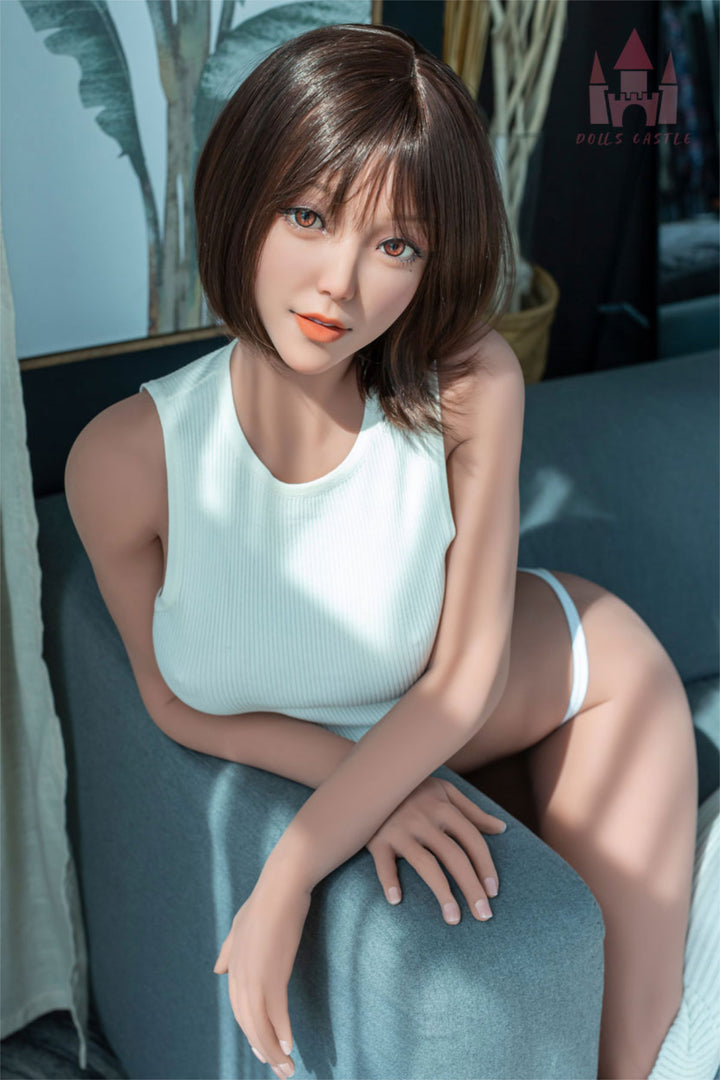 Dolls Castle® 163 cm E TPE - #K3 close-up upper body shot in white sleeveless top, short brown bob hair, teal indoor background
