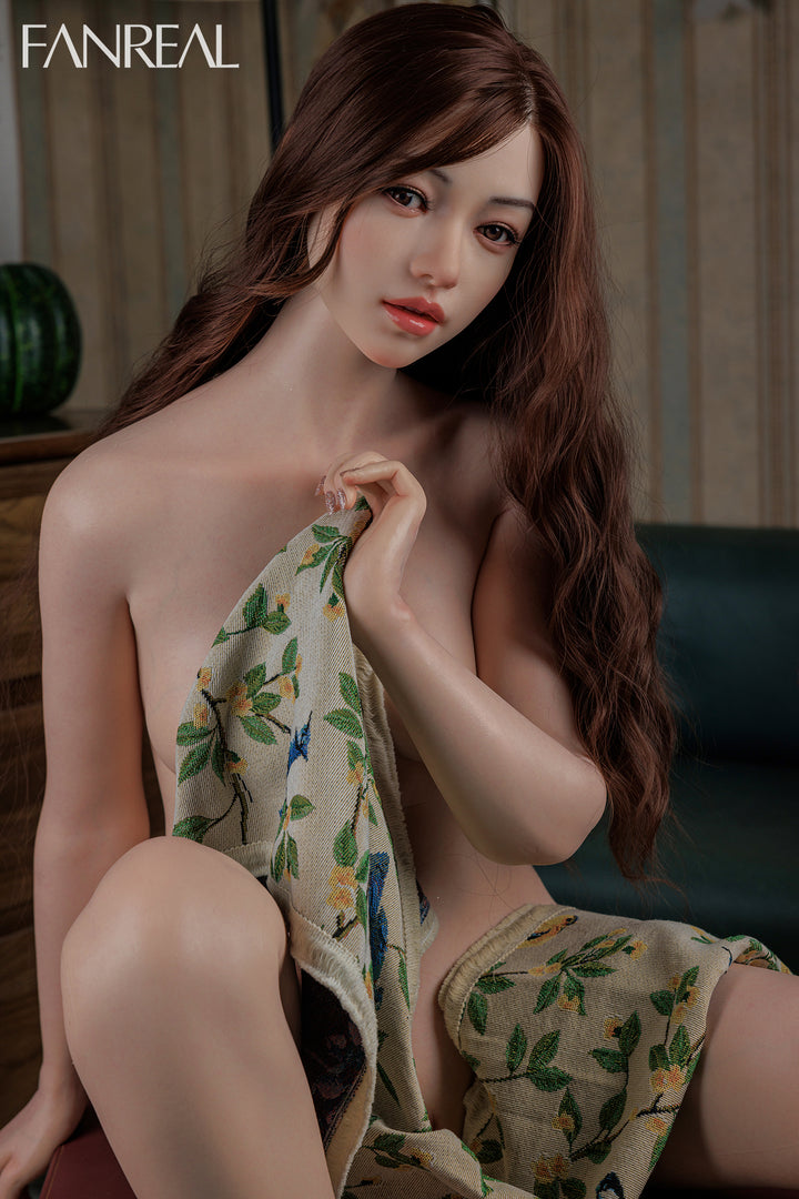 FANREAL Doll Yuki – 158cm B-Cup Realistic Silicone Sex Doll wrapped in a floral towel in a room setting.
