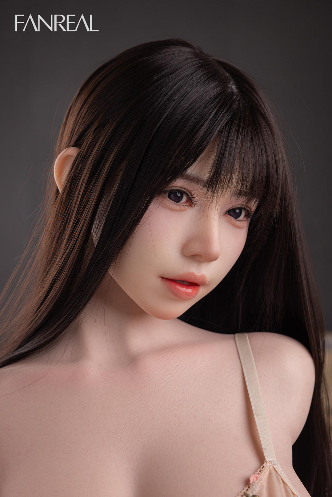 FANREAL DOLL T108 CM F Silicone Torso - Nora V2 seated close-up with the floral camisole loosened, bust visible, soft bedding backdrop