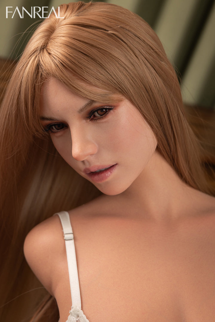 FANREAL DOLL T111CM F Silicone Torso - Mirella V2 – Close-up pose emphasizing sheer white lace panties with scalloped edge detailing, long strawberry-blonde hair falling loosely, softly lit curtain backdrop.