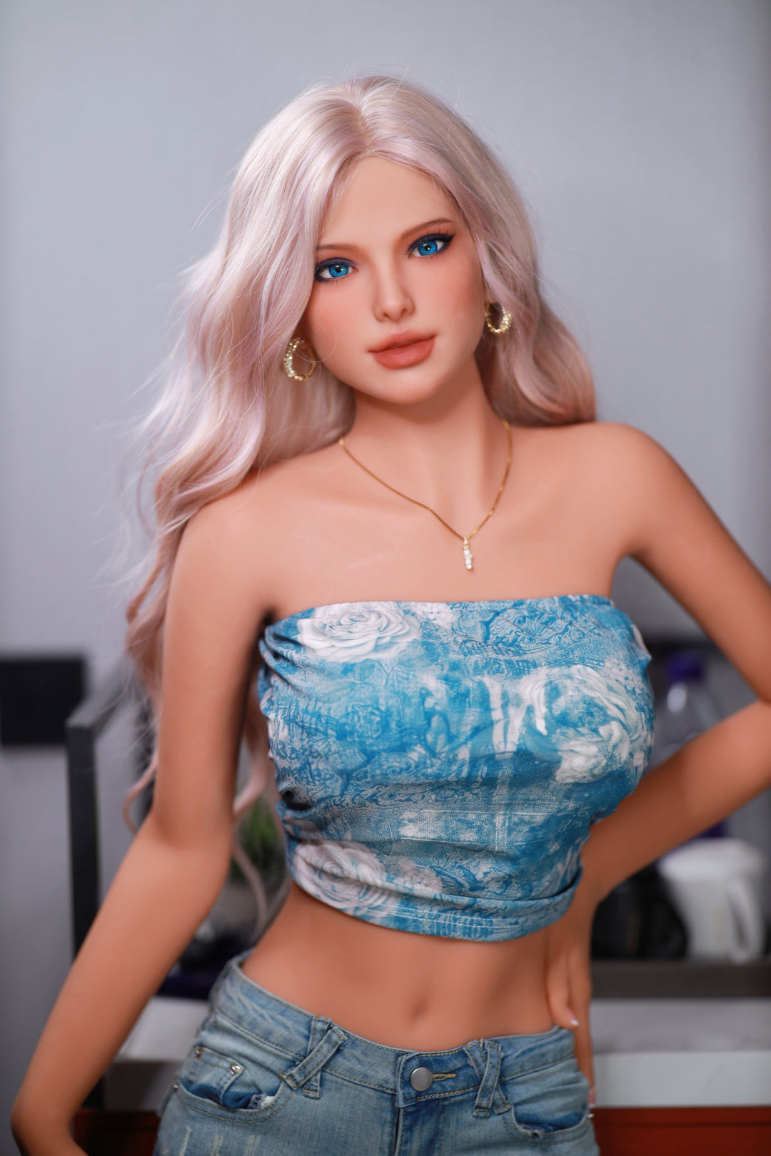 Fire Doll 166 cm C TPE - Flora full body standing pose in blue floral denim tube top and shorts, long pink-blonde wavy hair, bright indoor background
