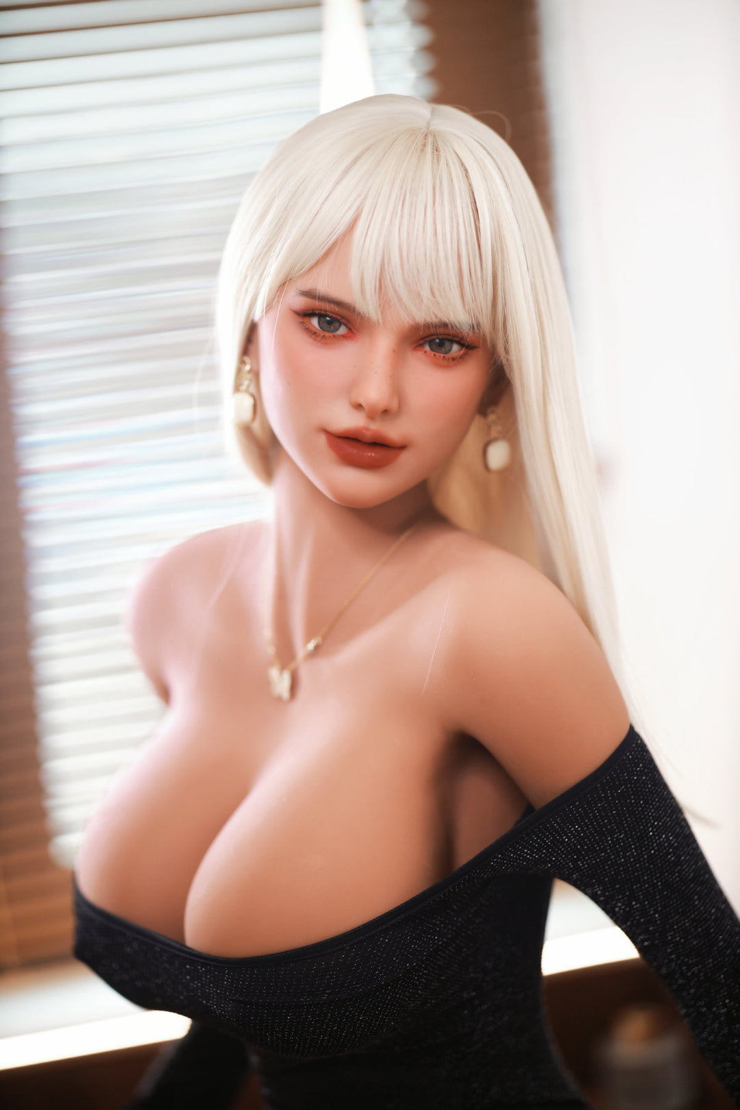 Fire Doll 166 cm E TPE - Hedi three-quarter view in black sleeveless dress, long white blonde hair, bright window background
