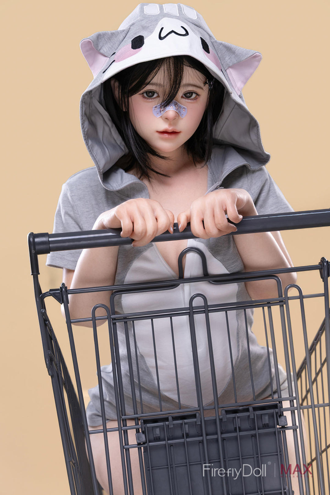 Firefly Diary Doll 151 cm A Silicone - Liuli wearing a gray hoodie with a cartoon design, sitting inside a black shopping cart.