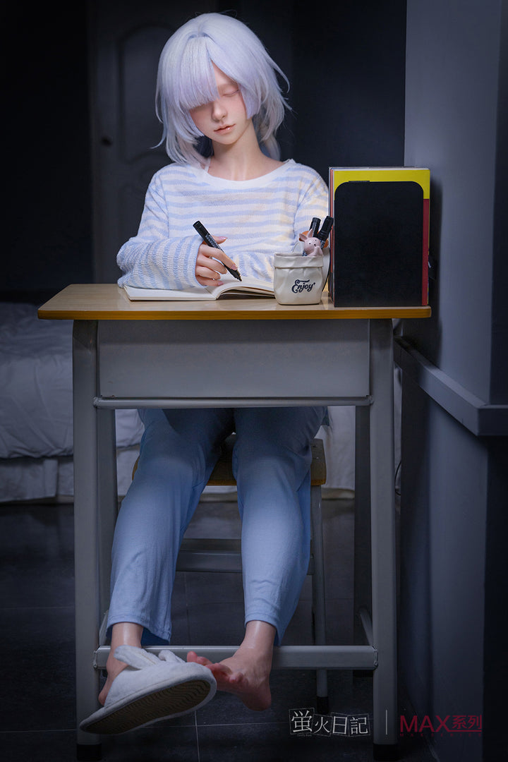 Firefly Diary Doll 153 cm A Max Series Silicone - Liuli V2 with white hair sitting at a desk with a notebook and pen, in a room setting.