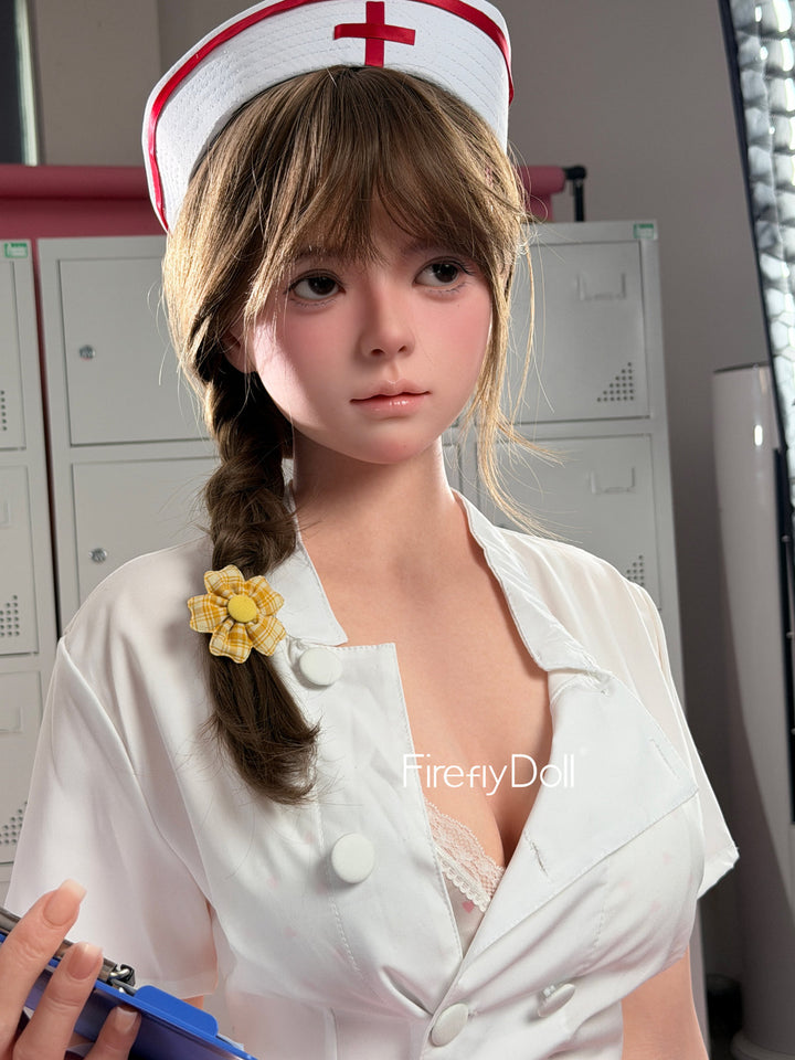 Firefly Diary Doll 159 cm Silicone - Liu Li V4 standing in a buttoned white nurse uniform and cap, wooden lockers behind her