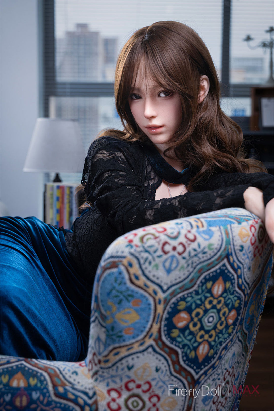 The Yelan doll sitting in an ornate blue and gold chair, wearing a black lace top and blue velvet skirt.