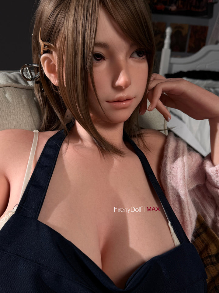 Firefly Diary Doll 164 CM I-Cup Max Series Silicone - Yuna upper body close-up view in navy apron holding teal mug, showcasing realistic silicone skin texture and I-cup chest craftsmanship
