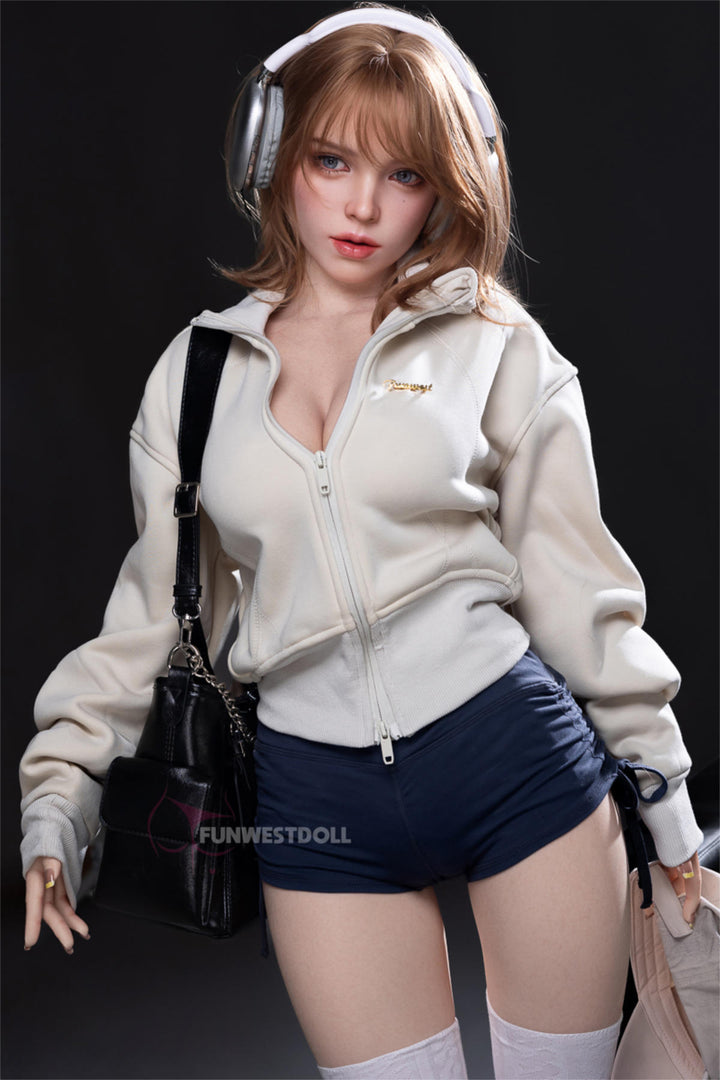 FunWest Doll 152 cm D Silicone - Thalia (Real Skin Texture) – standing in cream hoodie and denim shorts with a black backpack