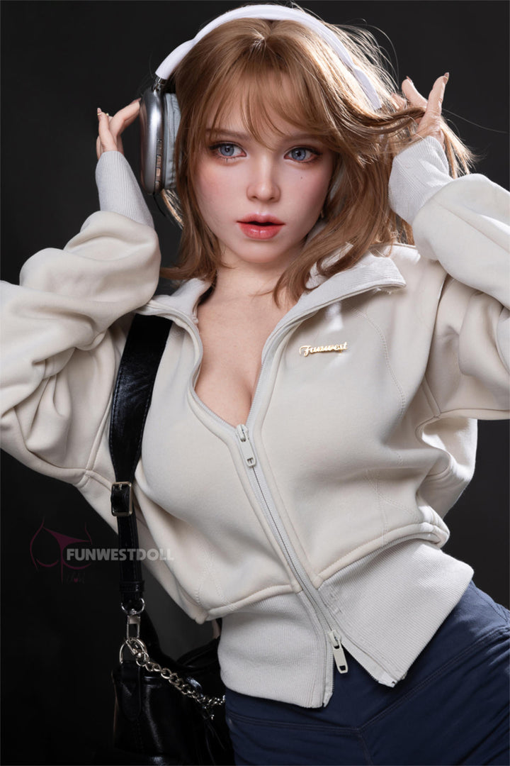 FunWest Doll 152 cm D Silicone - Thalia (Real Skin Texture) – three-quarter view in cream hoodie and denim shorts against a dark backdrop