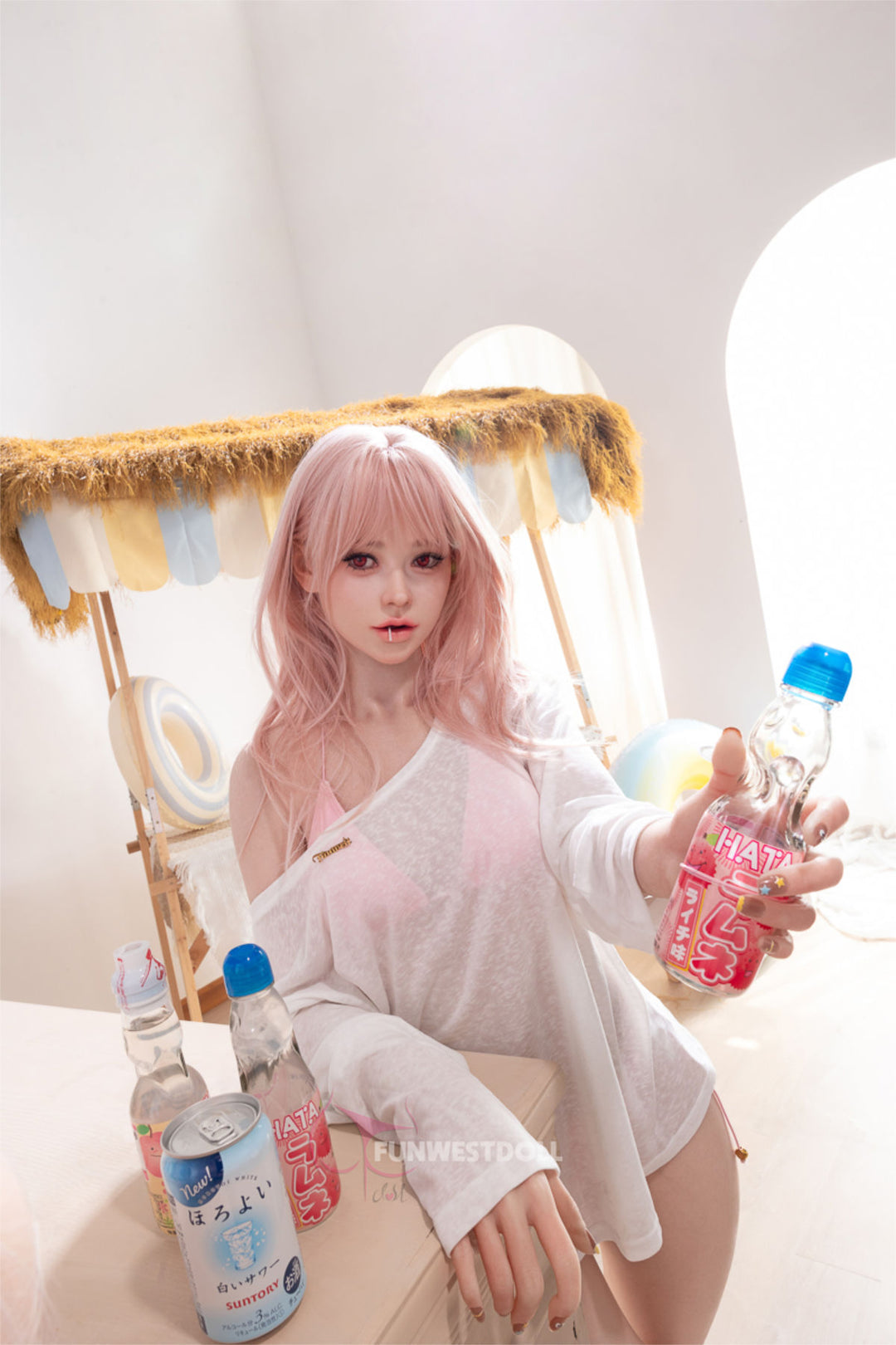 FunWest Doll 159 cm A Silicone - Lucy (Real Skin Texture) playful pose holding the blue water bottle up near her shoulder, sheer white blouse, wavy pink hair catching the light