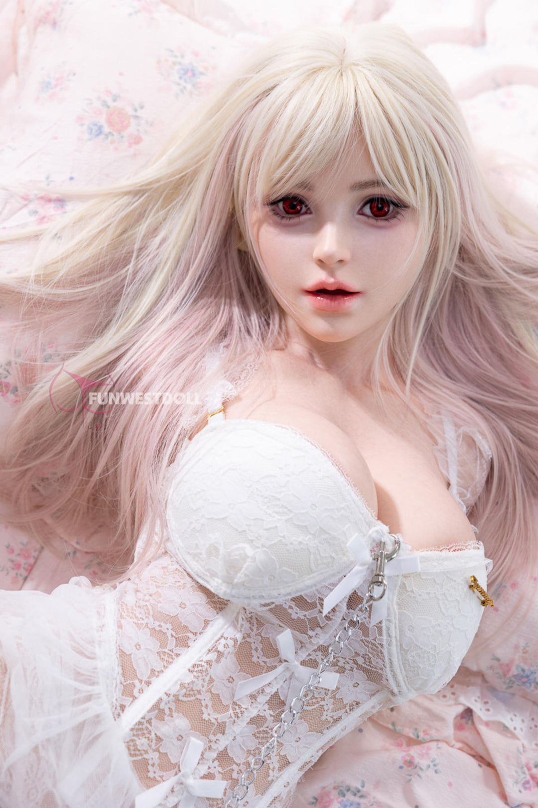 FunWest Doll 95 cm D FWT Series Silicone Torso - Lily V2 seated pose in a white lace lingerie set, platinum blonde hair falling over her shoulders, pink bedding