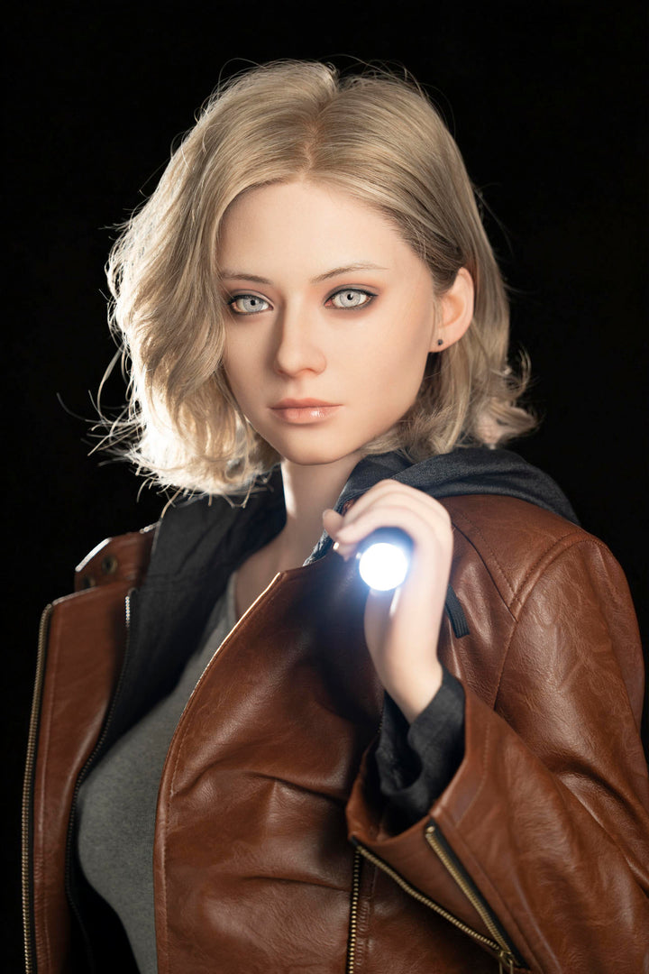 Game Lady 166 cm E Silicone - Grace – wavy shoulder-length blonde hair and blue eyes, brown leather jacket, holding a flashlight against a dark backdrop