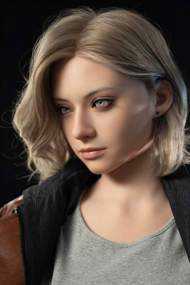 Game Lady 166 cm E Silicone - Grace – close-up portrait in a grey tee and brown leather jacket, soft wavy blonde hair
