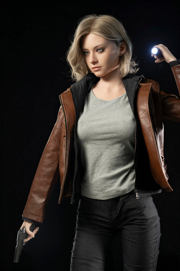 Game Lady 166 cm E Silicone - Grace – three-quarter view in a brown leather jacket, showing her E-cup curves under a fitted tee