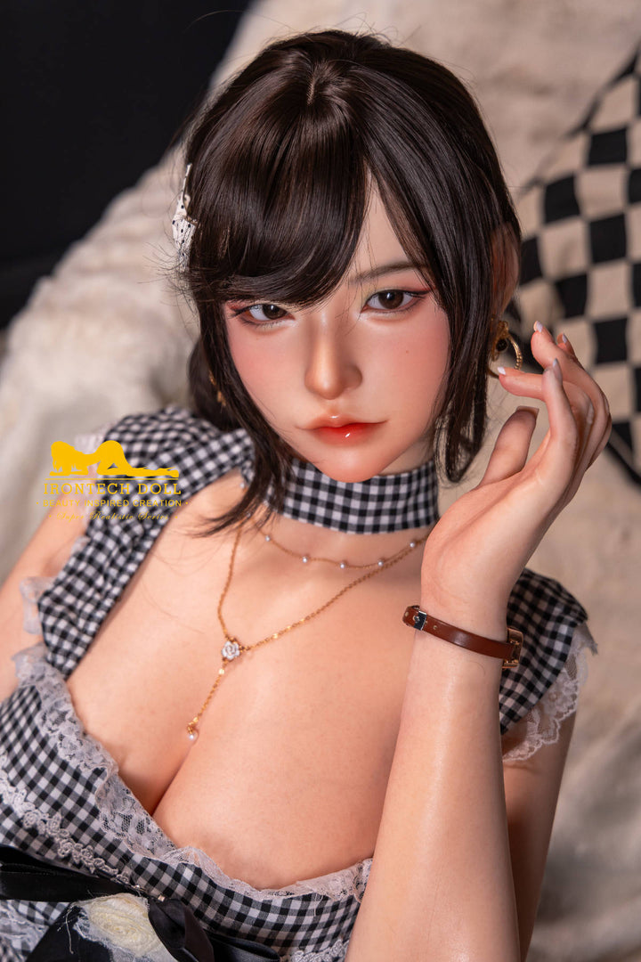 Irontech 165T E Young Series Silicone - Mio – dark bob with hair clip, black-and-white gingham top and choker, hand raised to her hair