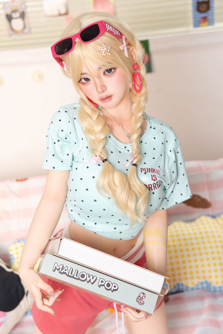 Irontech Doll 148 cm Plus B Silicone - Xia Ying three-quarter view in light blue polka dot crop jacket with blonde twin buns, bright kawaii bedroom background