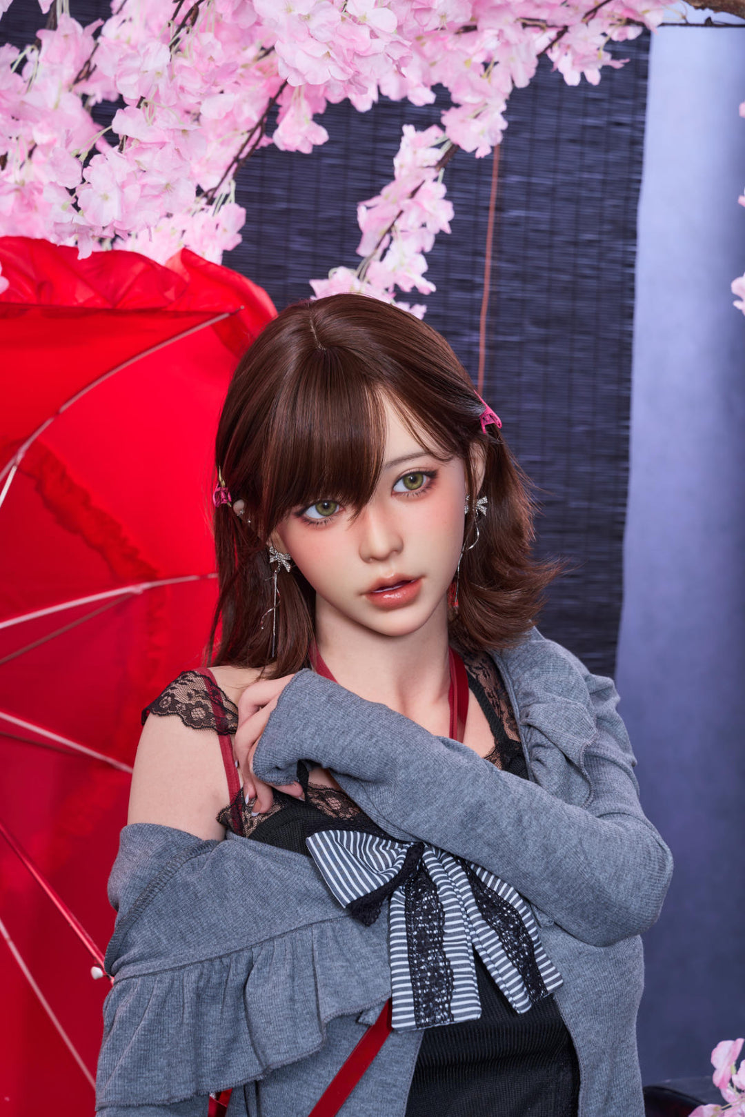 Waist-up view of the Irontech Doll 151 cm D Oriental Series Silicone – Yuna posing with a grey sweater and red ribbon details.