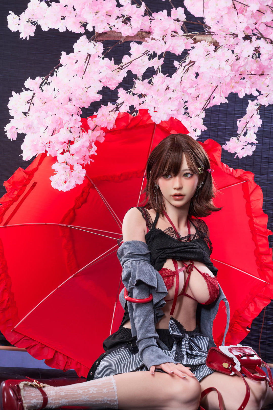 Irontech Doll 151 cm D Oriental Series Silicone – Yuna reclining on the floor next to a red traditional umbrella and pink blossoms.